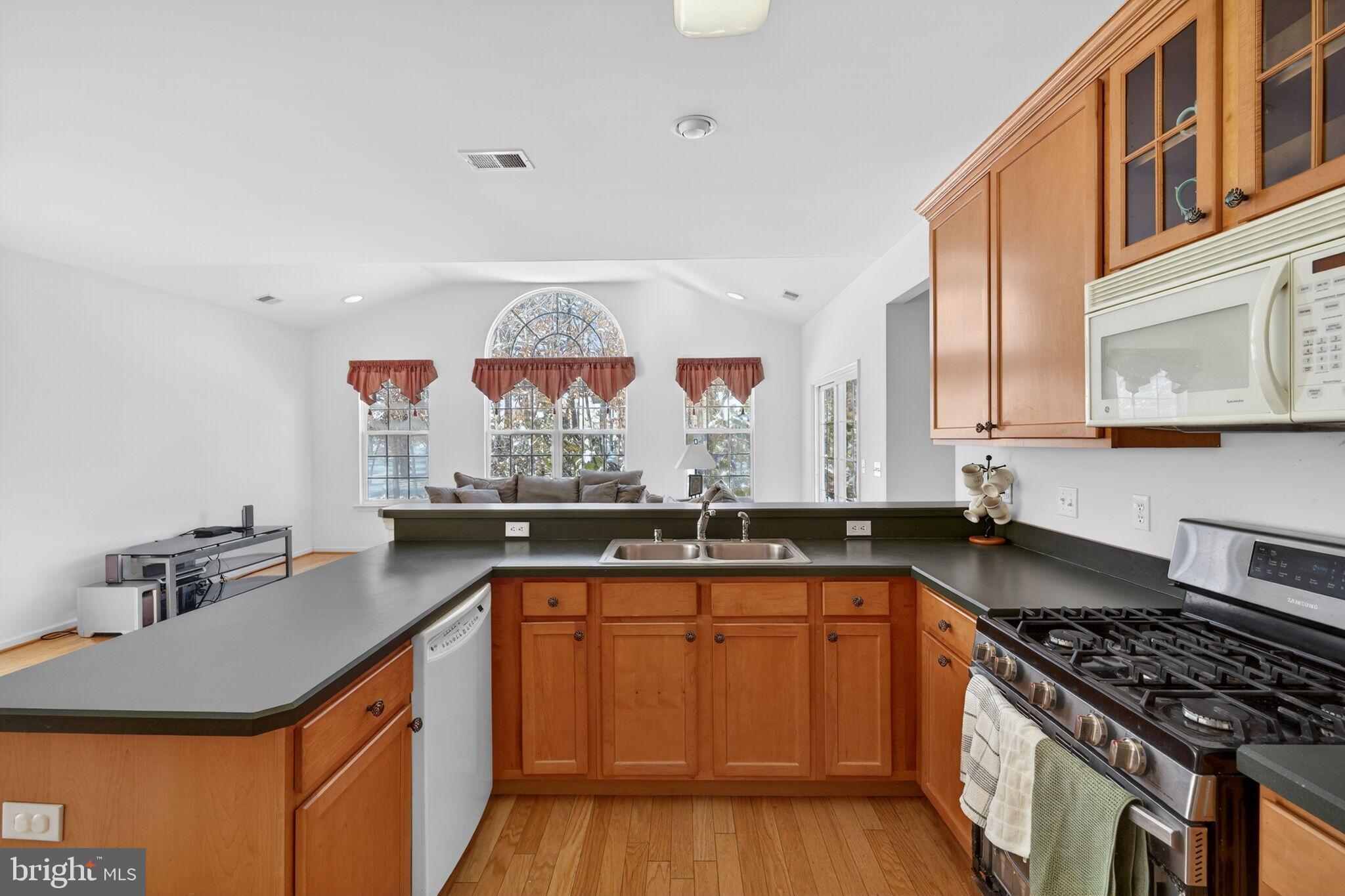 76 Portland Street Barnegat, NJ 08005 - Photo 21 of 47 a kitchen with stainless steel appliances granite countertop a sink stove and cabinets