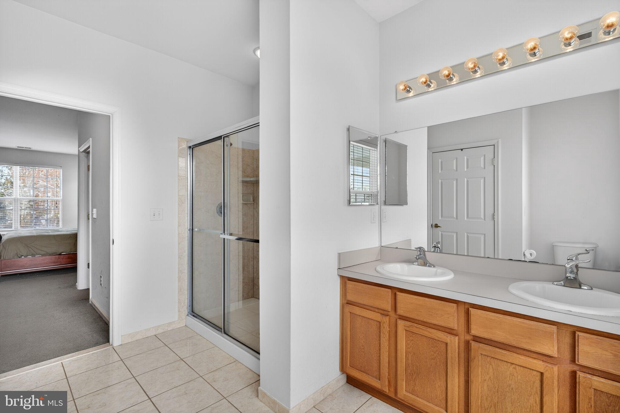 76 Portland Street Barnegat, NJ 08005 - Photo 37 of 47 a en suite bathroom with a double vanity sink a mirror and a