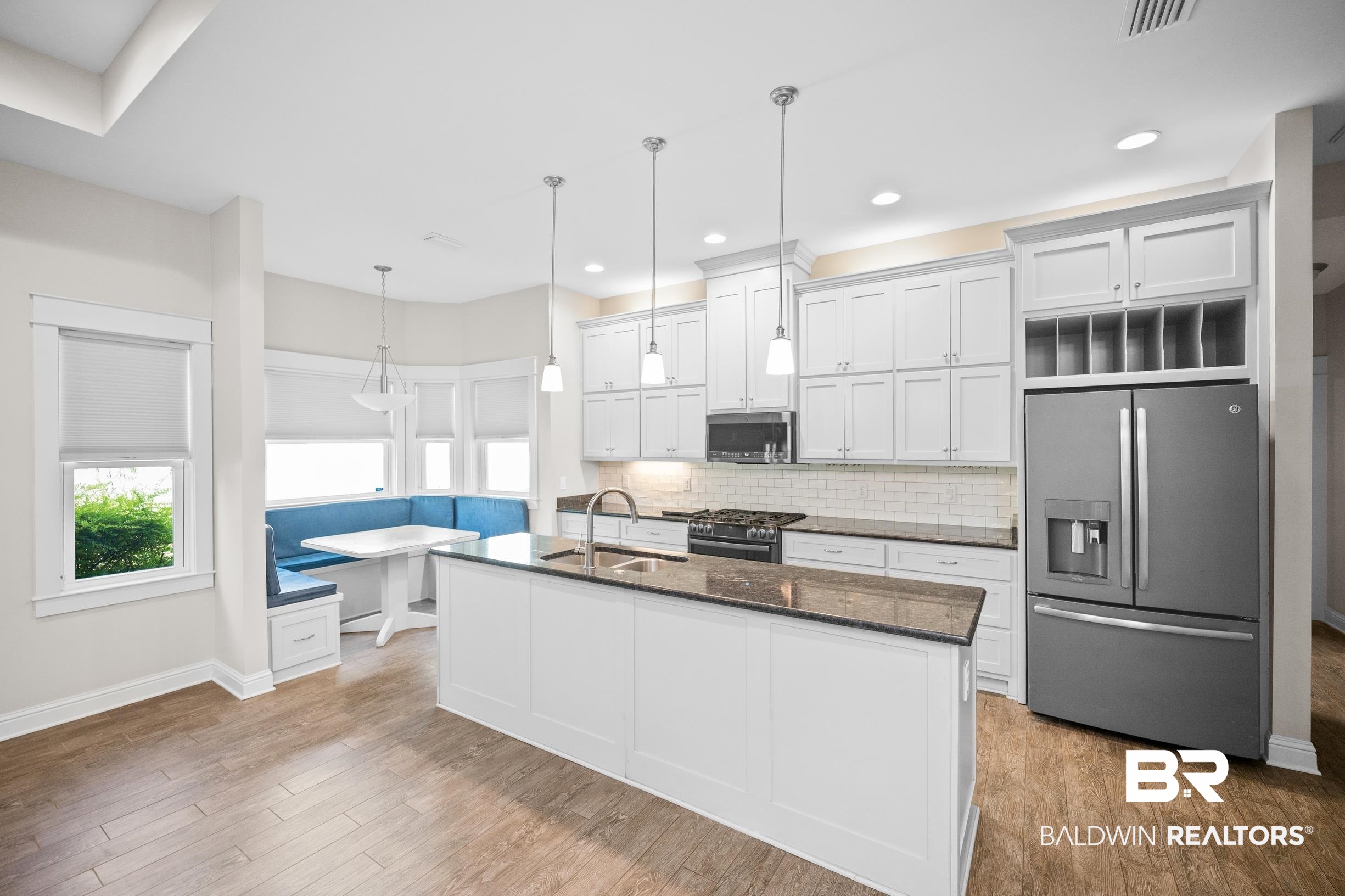 12254 Reunion Place Foley, AL 36535 - Photo 15 of 62 Kitchen with stainless steel appliances, a sink, decorative backsplash, wood finished floors, and recessed lighting
