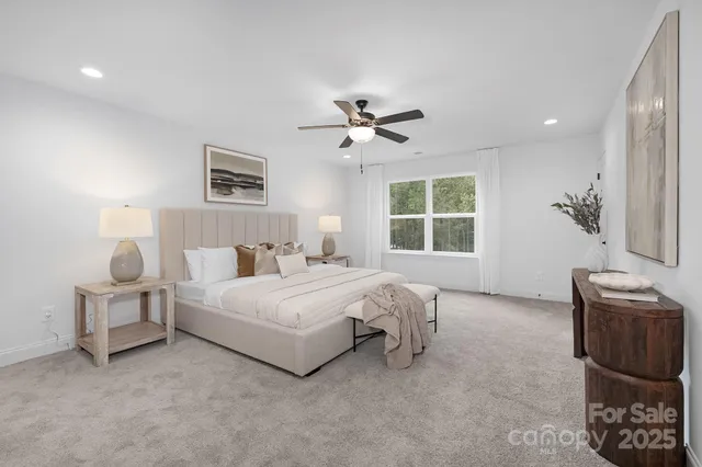 a spacious bedroom with a bed and a window