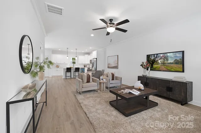 a living room with furniture and a mirror