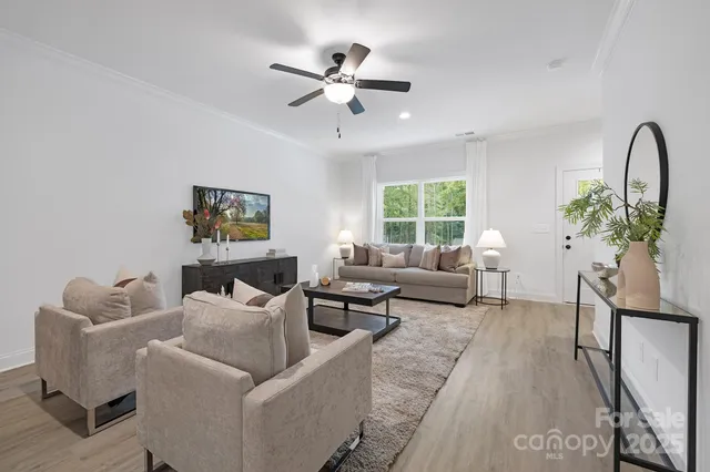 a living room with furniture and a potted plant
