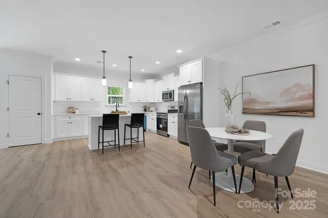 a dining room with furniture and wooden floor