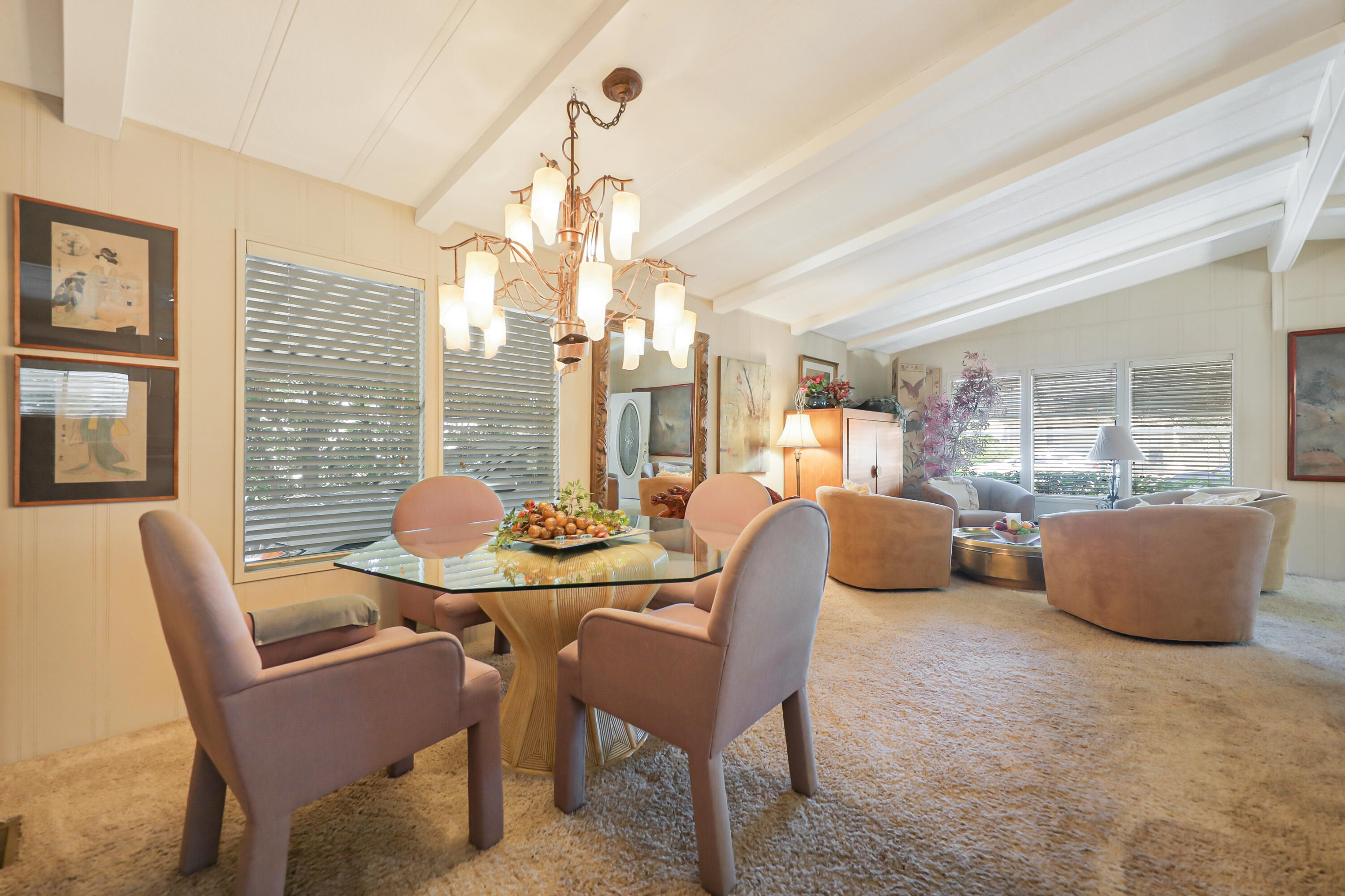 49305 Highway 74, Unit 86 Palm Desert, CA 92260 - Photo 15 of 31 a dining room with furniture a chandelier and wooden floor