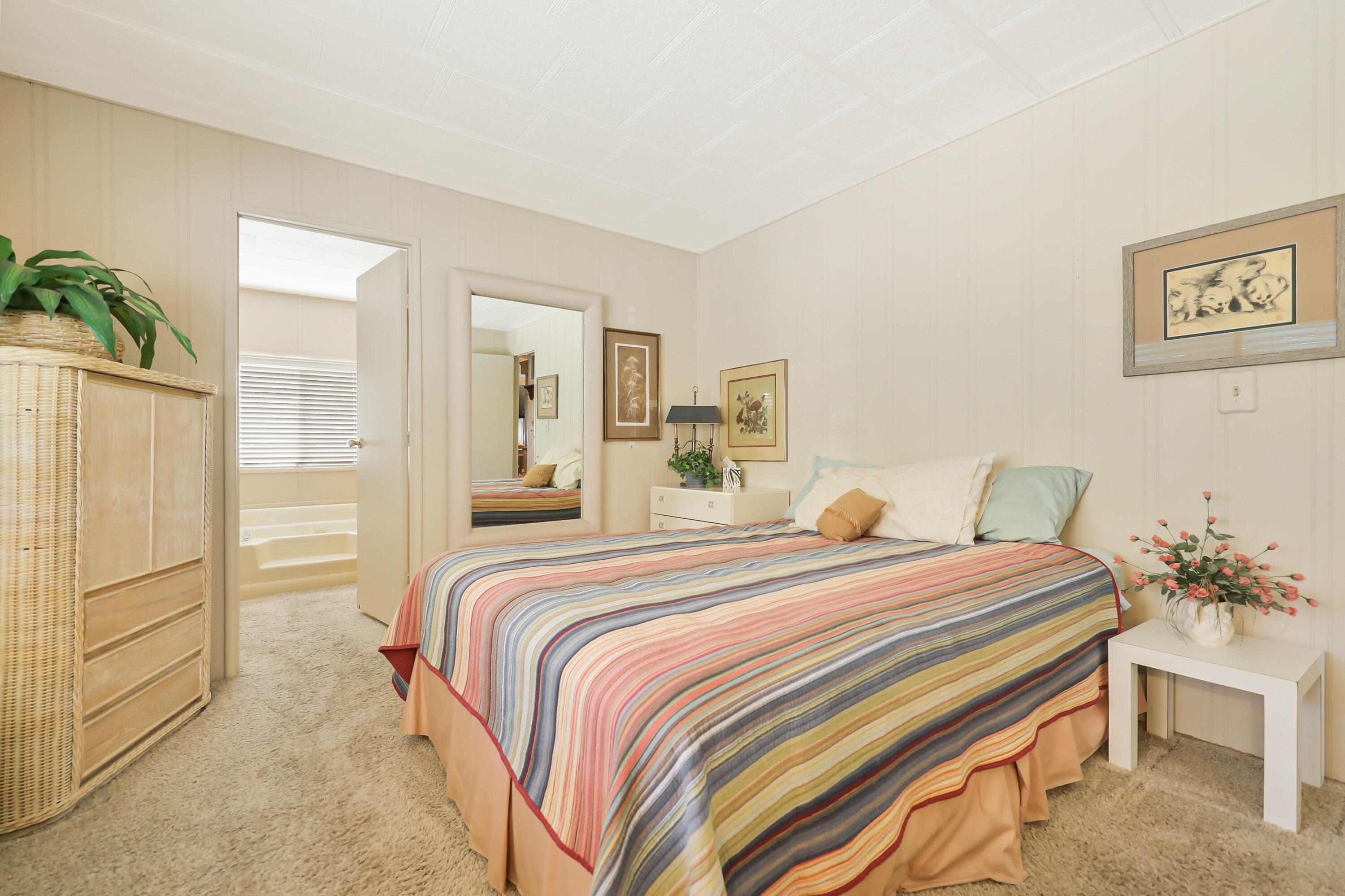 49305 Highway 74, Unit 86 Palm Desert, CA 92260 - Photo 18 of 31 a bedroom with a bed and a table