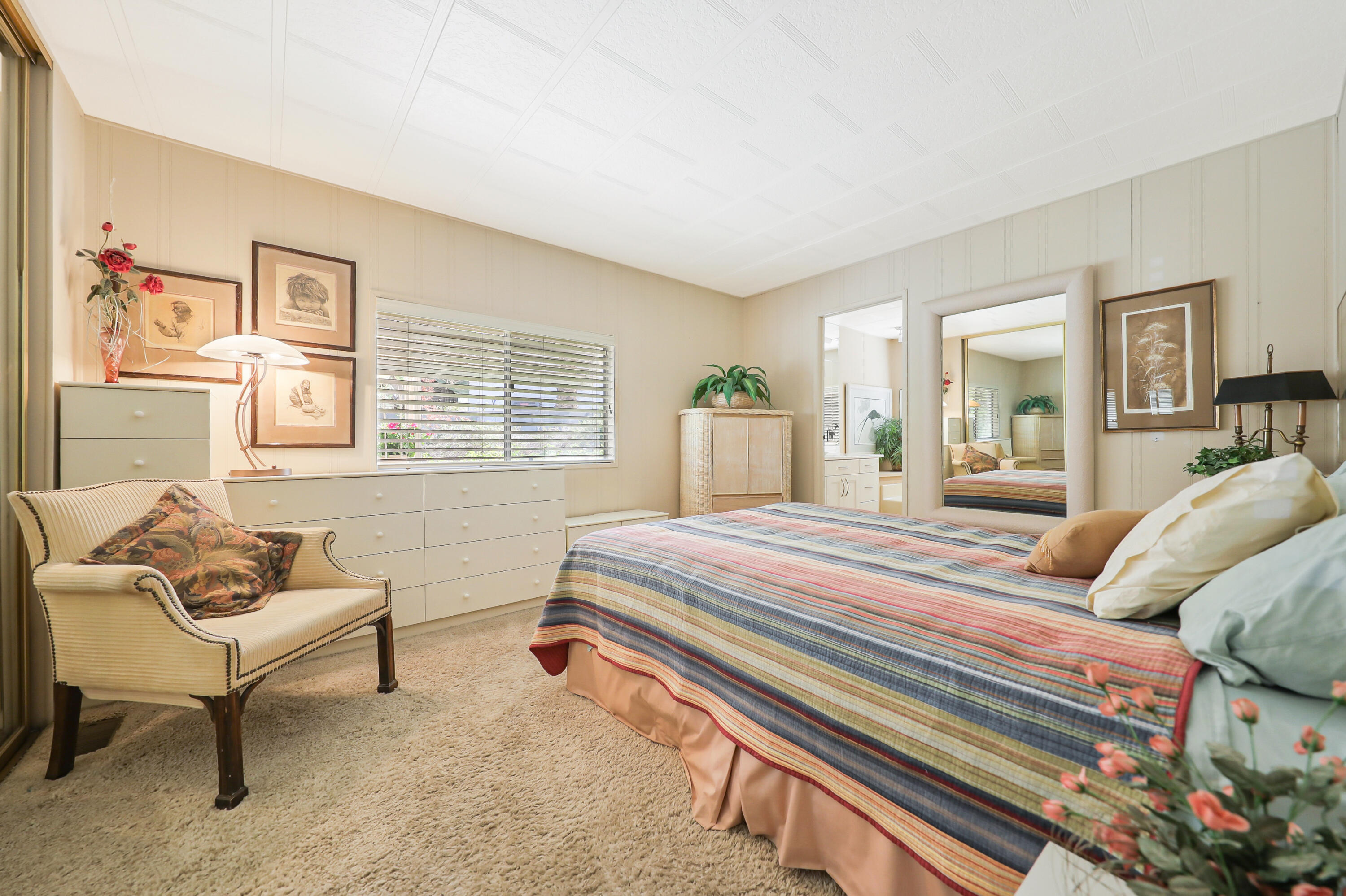 49305 Highway 74, Unit 86 Palm Desert, CA 92260 - Photo 19 of 31 a bedroom with a bed and a couch