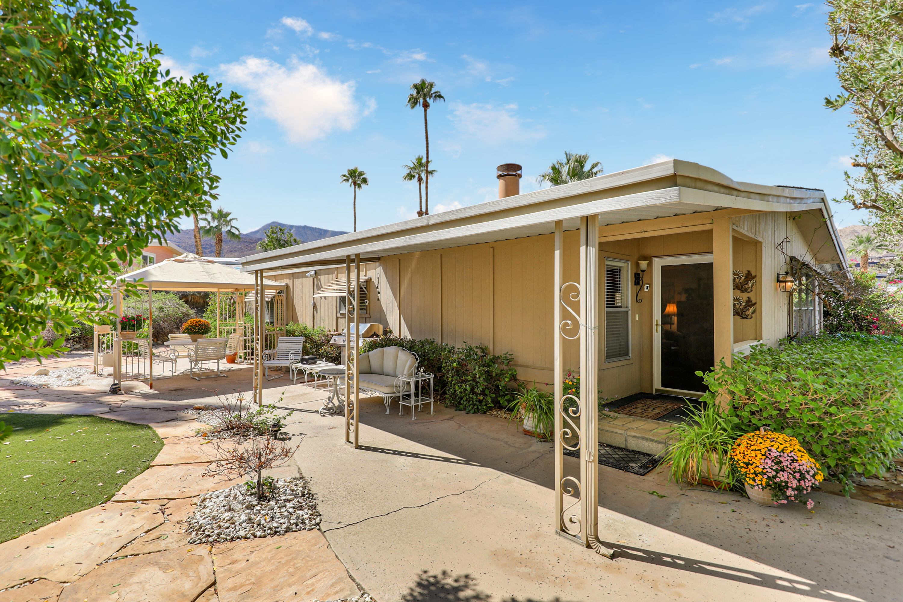 49305 Highway 74, Unit 86 Palm Desert, CA 92260 - Photo 2 of 31 a front view of a house with garden