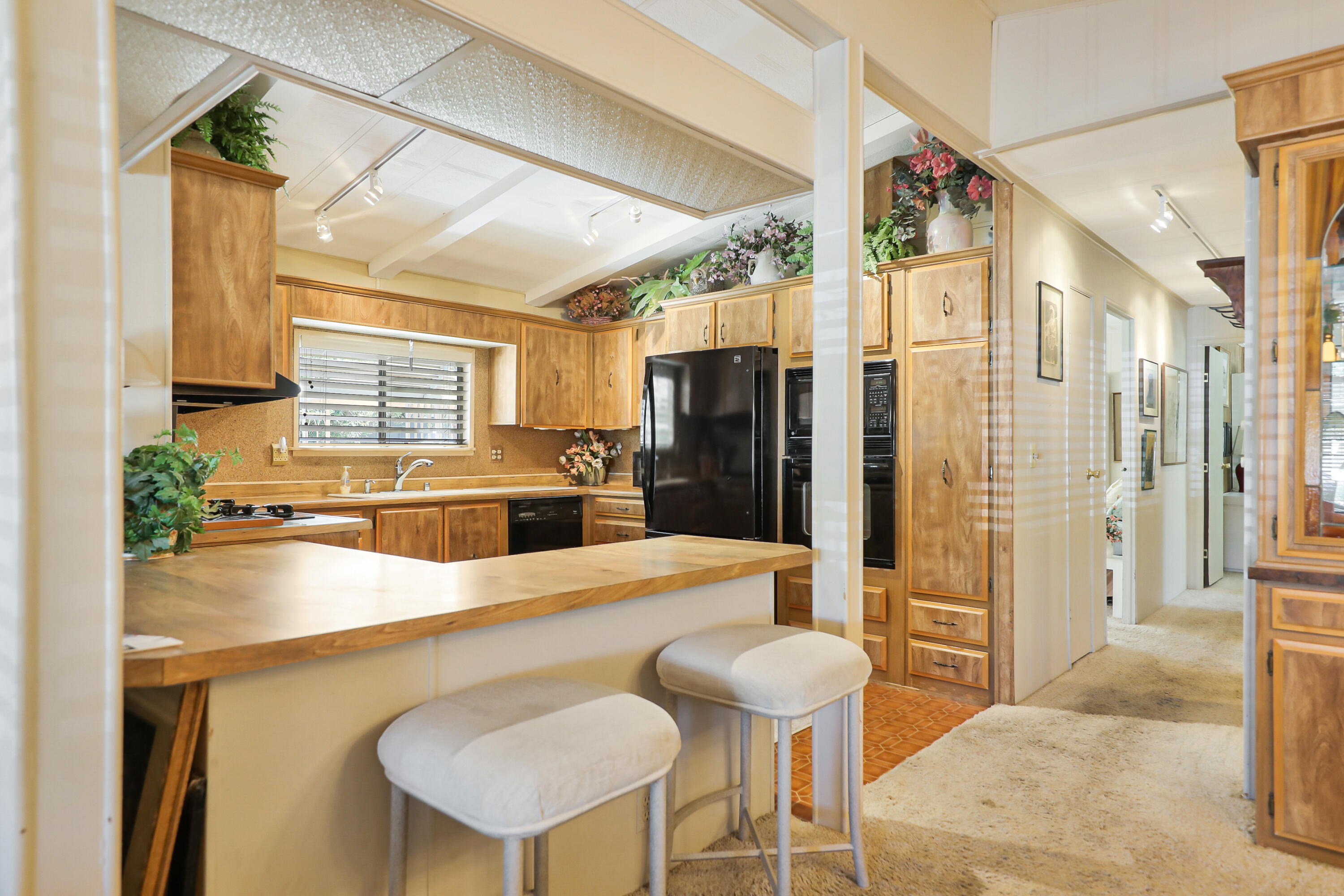 49305 Highway 74, Unit 86 Palm Desert, CA 92260 - Photo 10 of 31 a kitchen with stainless steel appliances kitchen island granite countertop a refrigerator and a stove