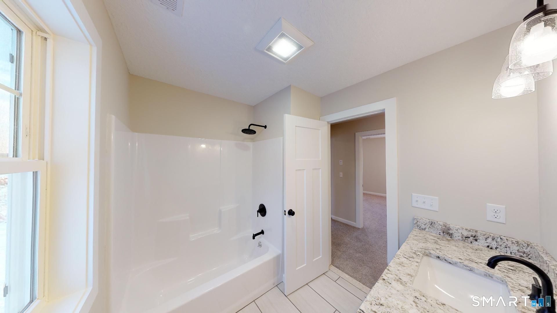 318 Capen Street Windsor, CT 06095 - Photo 16 of 30 a bathroom with a bathtub and a sink