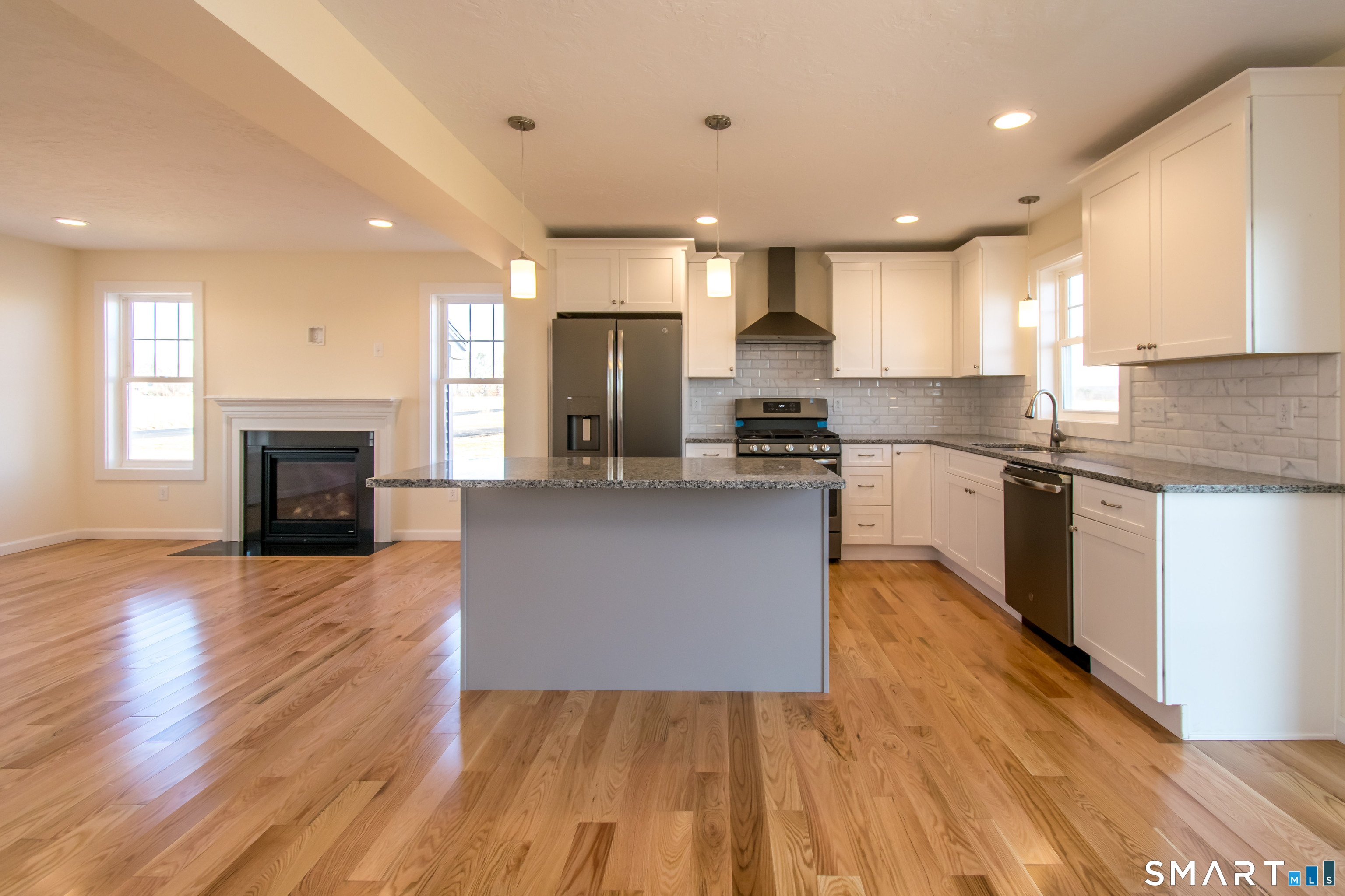 318 Capen Street Windsor, CT 06095 - Photo 18 of 30 a large kitchen with cabinets wooden floor and stainless steel appliances