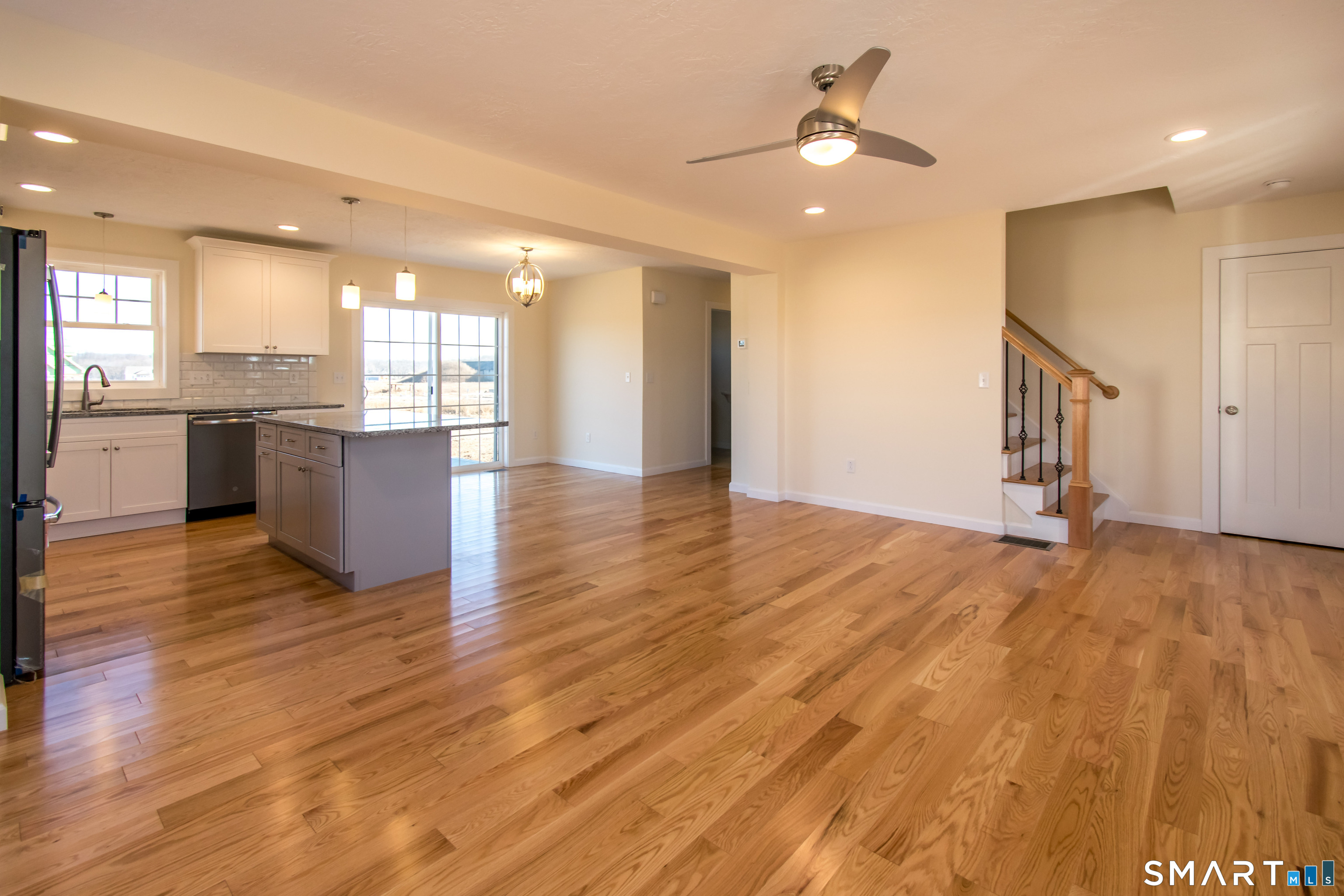 318 Capen Street Windsor, CT 06095 - Photo 22 of 30 a view of an empty room and kitchen with wooden floor