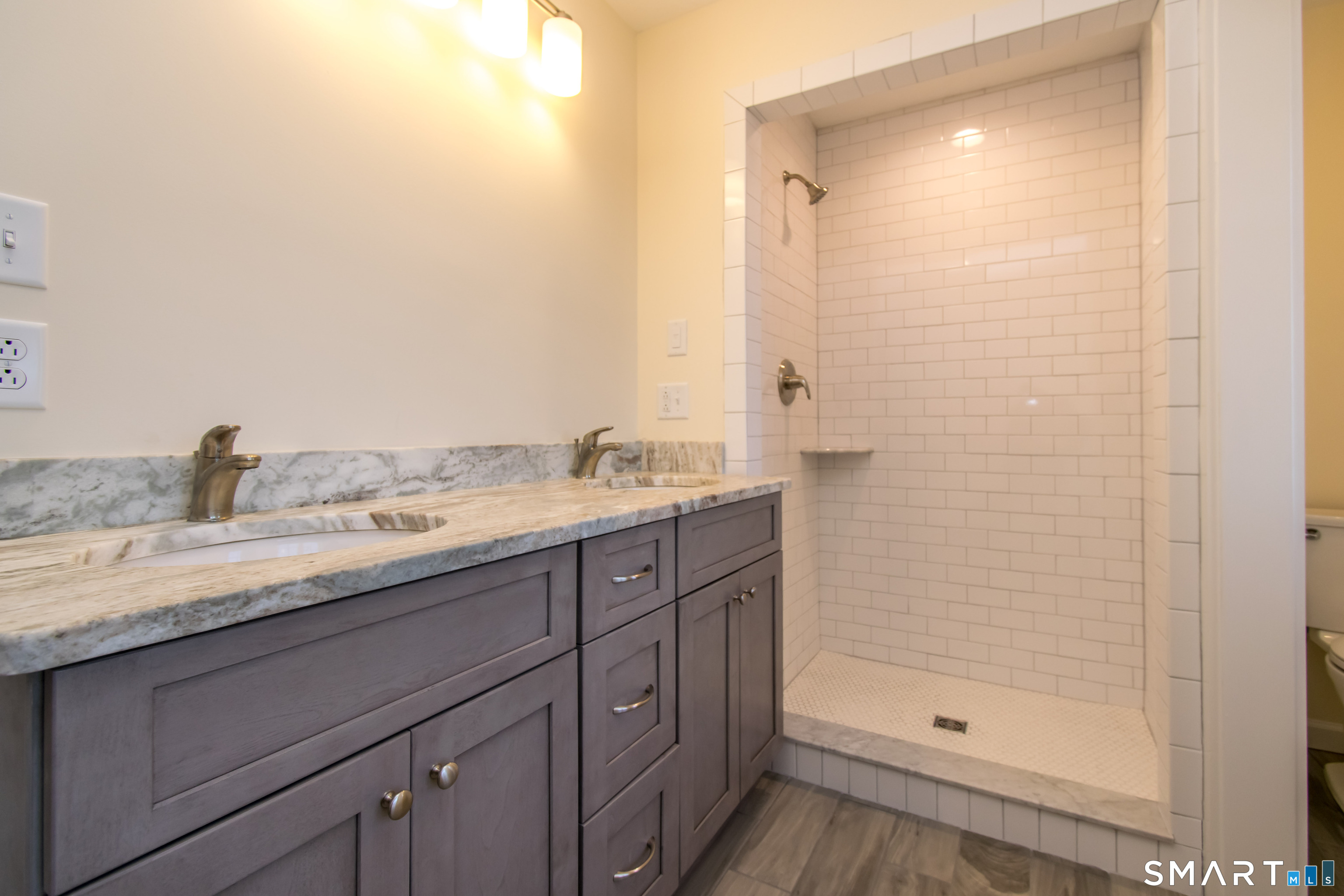 318 Capen Street Windsor, CT 06095 - Photo 24 of 30 a bathroom with a granite countertop sink a mirror and shower