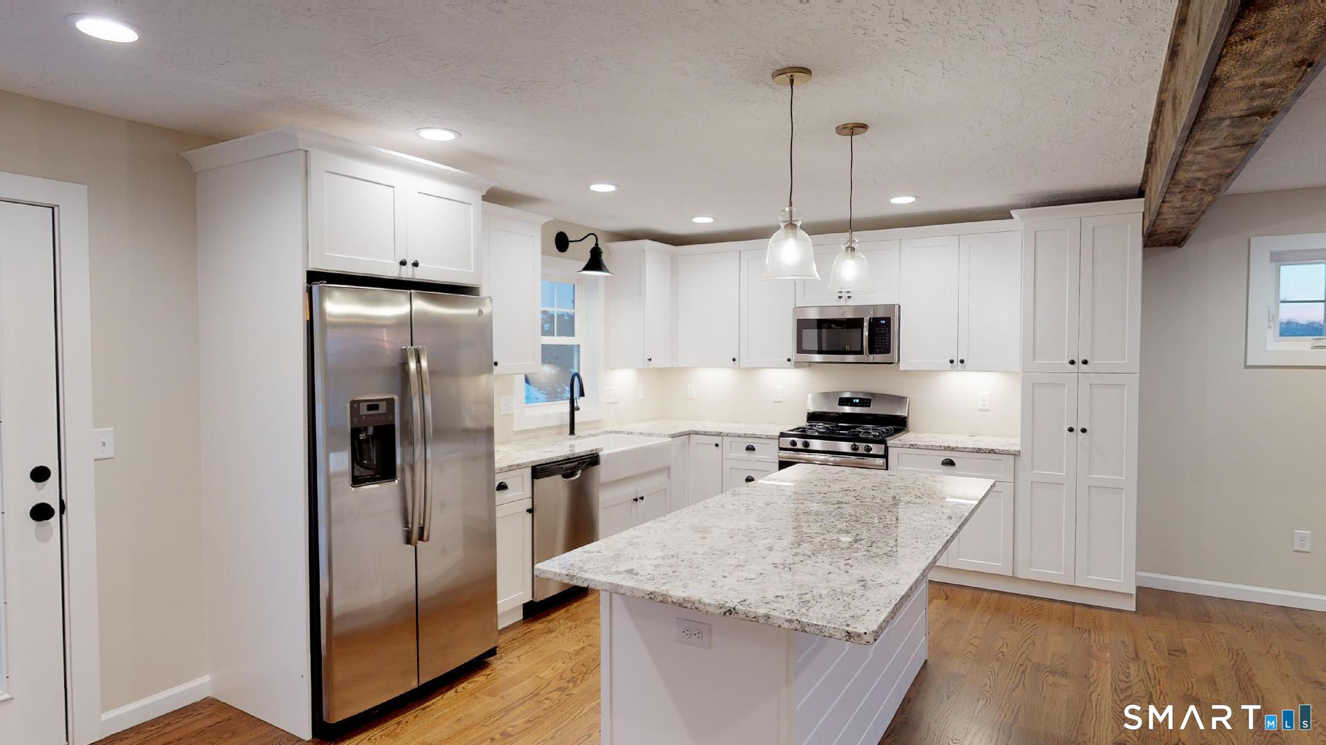 318 Capen Street Windsor, CT 06095 - Photo 5 of 30 a kitchen with a refrigerator a sink and wooden floor