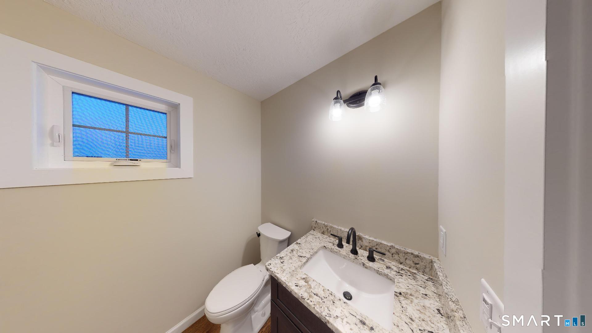318 Capen Street Windsor, CT 06095 - Photo 9 of 30 a bathroom with a sink vanity mirror and toilet