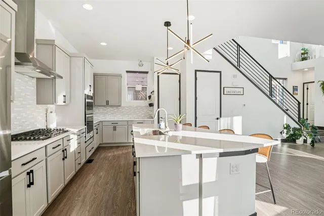 a kitchen with sink stove and refrigerator