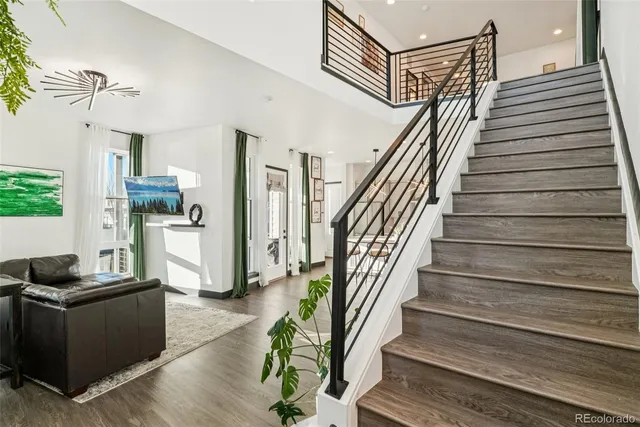 a view of entryway and hall with wooden floor