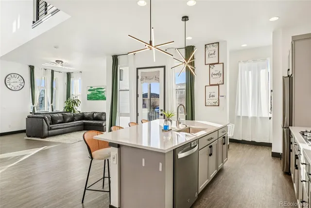 a open kitchen with a sink stove and wooden floor