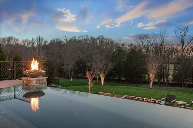 a bedroom with a bed and a flat tv screen on the dresser