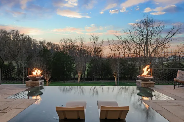 a living room with furniture a piano and a potted plant