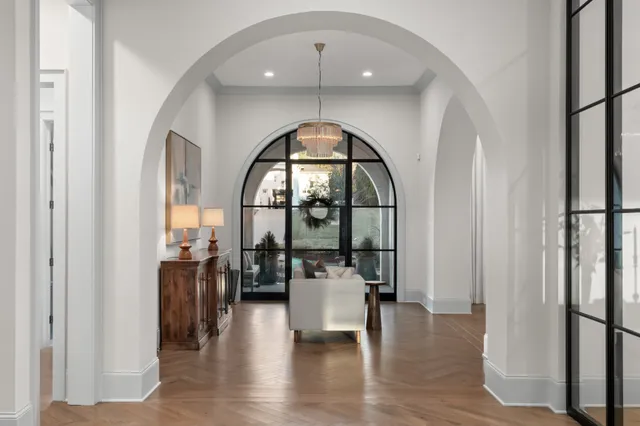 a view of a hallway and a livingroom with furniture