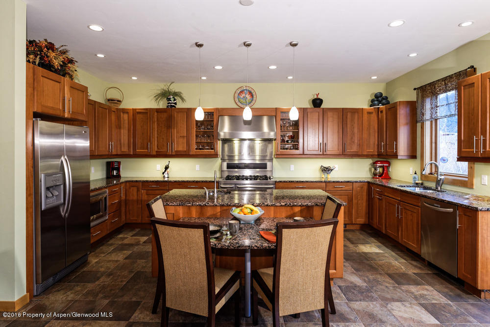 344 Sopris Circle Basalt, CO 81621 - Photo 6 of 31 a kitchen with stainless steel appliances granite countertop a refrigerator a stove top oven and a sink with cabinets