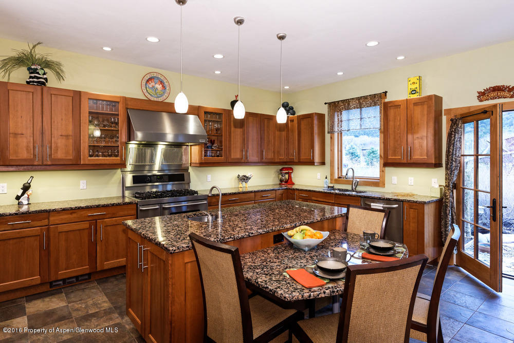 344 Sopris Circle Basalt, CO 81621 - Photo 8 of 31 a kitchen with stainless steel appliances granite countertop a stove a sink dishwasher and cabinets with wooden floor