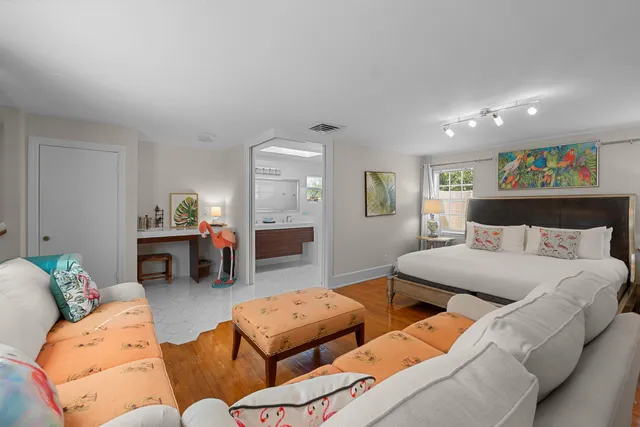 a bedroom with two beds and a couch