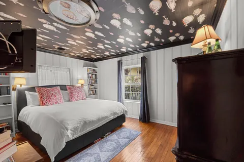 a dining room with furniture a chandelier and kitchen view