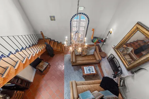 a kitchen with stainless steel appliances granite countertop a refrigerator a sink dishwasher a dining table and chairs with wooden floor