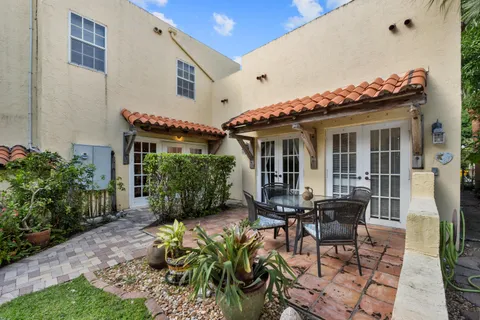 a living room with furniture a chandelier and a fireplace