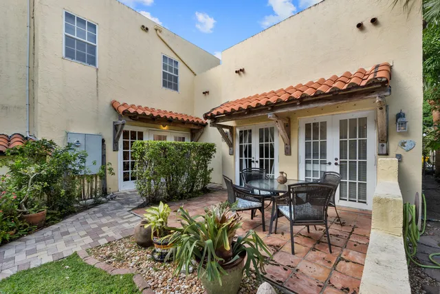 a living room with furniture a chandelier and a fireplace