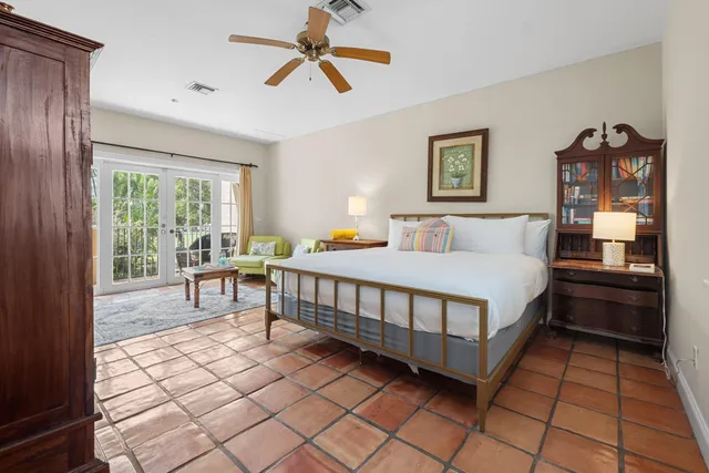 a spacious bedroom with two beds and a chandelier