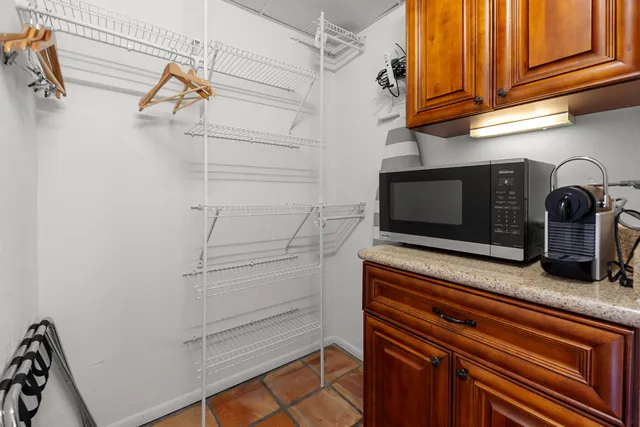a kitchen that has a sink and white cabinets