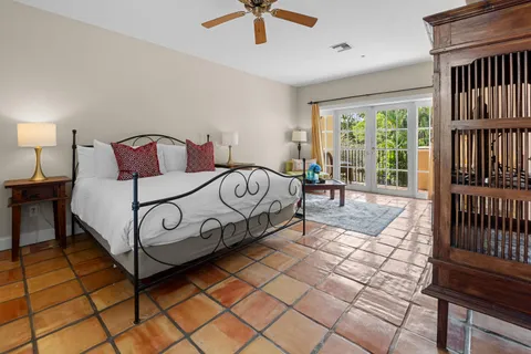 a bed sitting in a bedroom next to a window