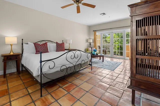 a bed sitting in a bedroom next to a window