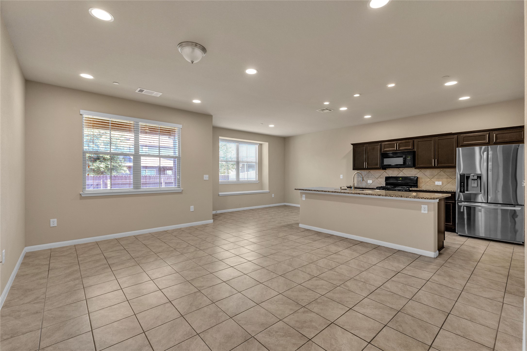 2880 Donnell Drive, Unit 2003 Round Rock, TX 78664 - Photo 4 of 31 Open-concept living area with tiled flooring and recessed lighting