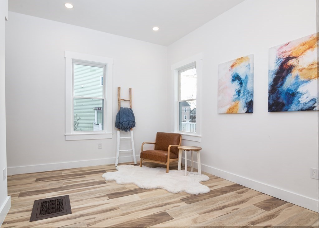 84 Dudley Street Medford, MA 02155 - Photo 13 of 27 a bedroom with a bed and a chair
