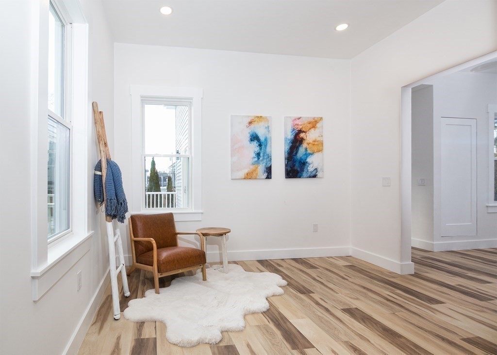 84 Dudley Street Medford, MA 02155 - Photo 14 of 27 a bedroom with a bed and a painting on the wall