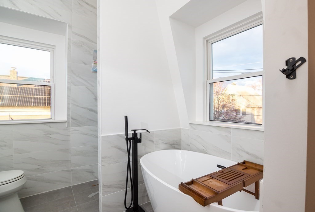 84 Dudley Street Medford, MA 02155 - Photo 18 of 27 a bathroom with a tub and a window