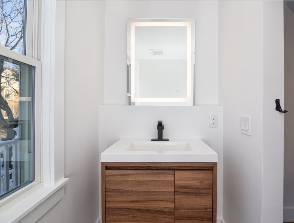 84 Dudley Street Medford, MA 02155 - Photo 19 of 27 a bathroom with a sink and a mirror
