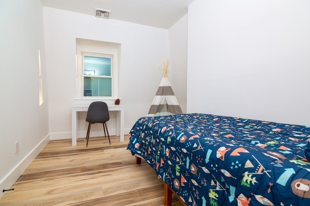 84 Dudley Street Medford, MA 02155 - Photo 23 of 27 a bedroom with a bed and a window