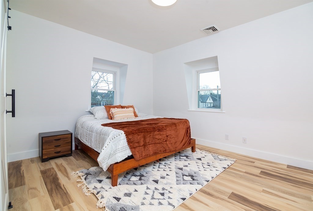 84 Dudley Street Medford, MA 02155 - Photo 24 of 27 a bedroom with a bed and a window