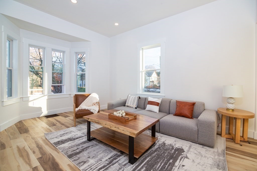 84 Dudley Street Medford, MA 02155 - Photo 5 of 27 a living room with furniture and a large window