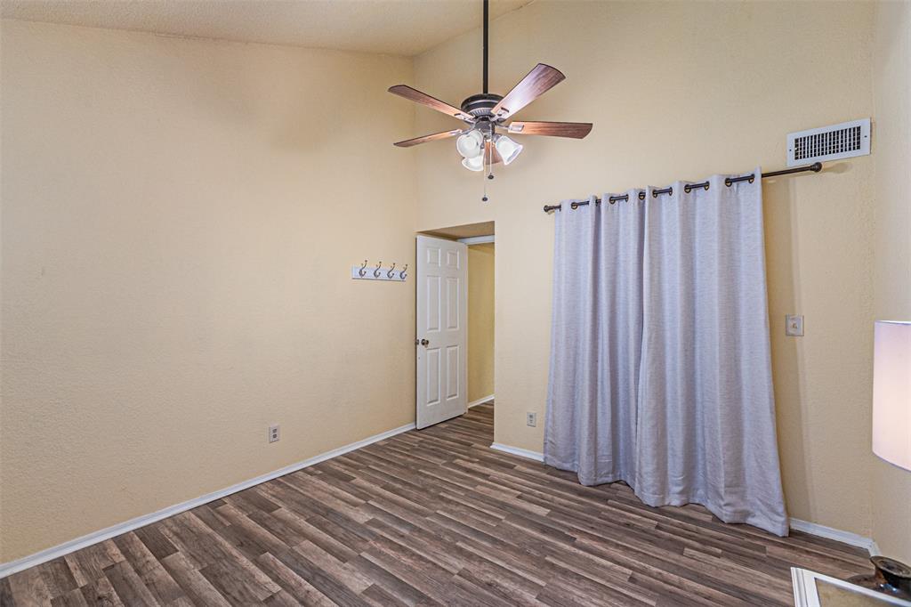 5590 Spring Valley Road, Unit C205 Dallas, TX 75254 - Photo 12 of 25 Primary Bedroom featuring dark wood-style floors and a ceiling fan