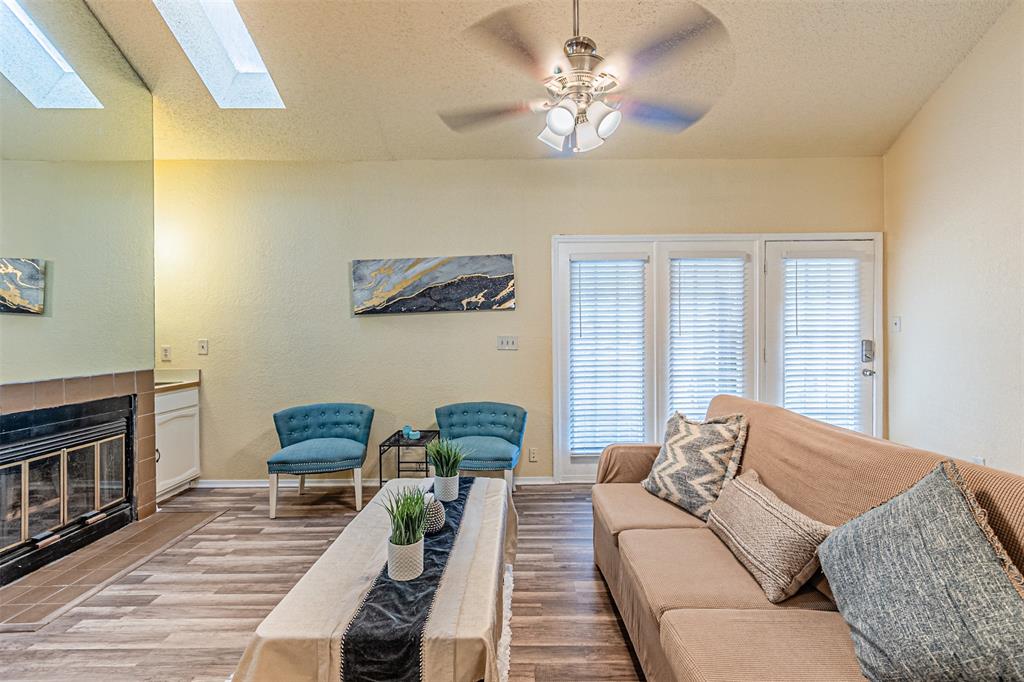 5590 Spring Valley Road, Unit C205 Dallas, TX 75254 - Photo 3 of 25 Living area with wood finished floors, plenty of natural light