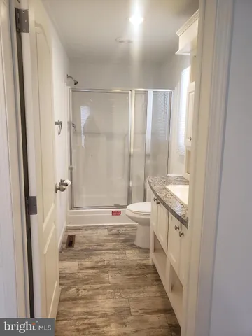 a bathroom with a double vanity sink toilet mirror and bathtub