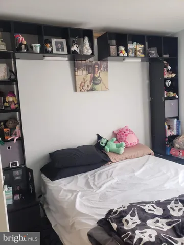 a bedroom with a bed and cabinets