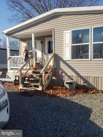 a view of a house with a small yard and wooden fence