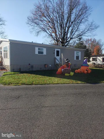 a front view of house with yard and trees