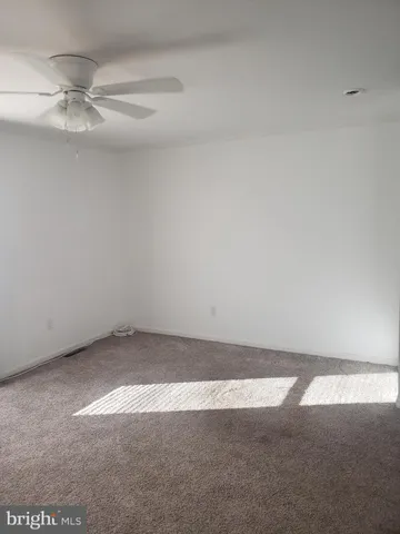 an empty room with a fan